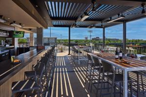 a bar with tables and chairs on the roof of a building at Crowne Plaza North Augusta, by IHG in North Augusta