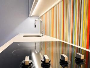 a kitchen with a sink and a striped wall at The C Park Hotel and Suites in Toronto