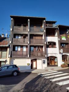 a car parked in front of a building with balconies at L'HappyMijoux in Mijoux