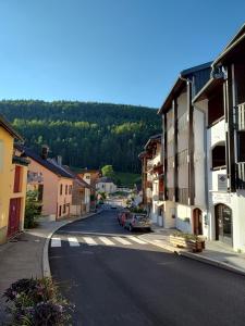 a street in a small town with a car on the road at L'HappyMijoux in Mijoux +49 photos