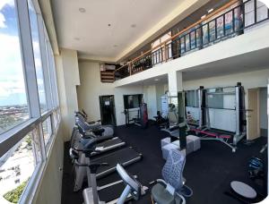 a gym with cardio equipment in a building at Azure Luxe Haven by Irene in San Fernando