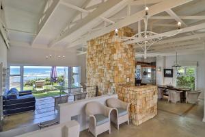 a large living room with a large stone wall at Vinho Verde Splendid Sea View Jacuzzi in Franskraalstrand