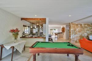 a living room with a pool table and a kitchen at Vinho Verde Splendid Sea View Jacuzzi in Franskraalstrand