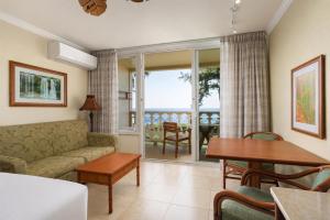 a living room with a couch and a table at Aston Islander On The Beach in Kapaa