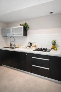 a kitchen with a sink and a stove at 2 Br Apartment In Savyoney Tower W Room in Jerusalem +14 photos