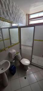 a bathroom with a toilet and a sink at Hostal Casa Lulú Santa Marta in Santa Marta +52 photos