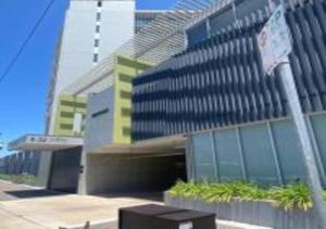 a large building with a building with a tallraper at Nature Meets City on Mint in Townsville