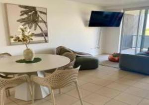 a living room with a white table and chairs at Nature Meets City on Mint in Townsville