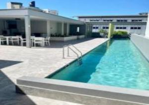 a swimming pool on the side of a building at Nature Meets City on Mint in Townsville