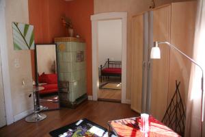 a living room with a room with a red couch at Radstation Menz in Menz