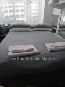 a bed with two towels on top of it at Marine Guest House in Eastbourne