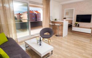 a living room with a couch and a table and a tv at Apartments & Rooms Danivan Pool Villas - Off site breakfast available in Novalja