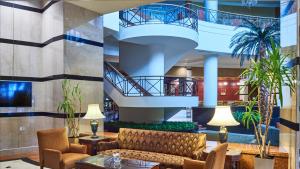 a lobby with a couch and a staircase at InterContinental Almaty by IHG in Almaty