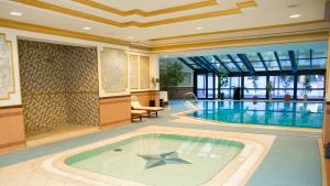 a swimming pool with a star in the middle at InterContinental Almaty by IHG in Almaty