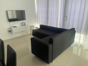 a living room with a couch and a tv at Casa Miranda in Mindelo