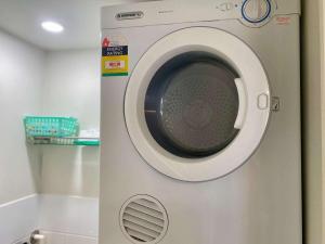 a white washing machine sitting in a room at Tranquil 3 Bedroom Retreat in Townsville City in Townsville