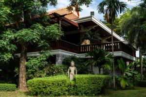 a house with a statue in front of it at Try Palace Resort Kep in Kep