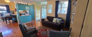 a living room with a couch and a table at Serendip in Point Lonsdale