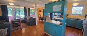 a kitchen and living room with a blue cabinet at Serendip in Point Lonsdale