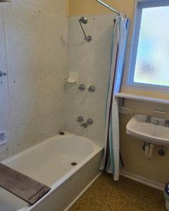 a bathroom with a shower and a tub and a sink at Serendip in Point Lonsdale +15 photos