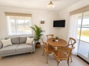 a living room with a couch and a table at BIG4 Robe Lakeside Tourist Park in Robe