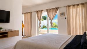 a bedroom with a bed and a sliding glass door at Old Harbour Oasis in Old Harbour