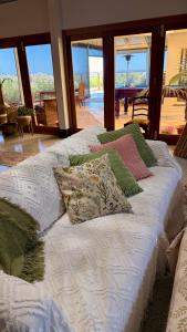 a group of pillows on a bed in a room at Love at Sellicks Chills in Sellicks Hill +56 photos