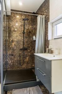 a bathroom with a shower and a sink at Gauja Lakeside in Gauja +75 photos