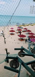 a beach with a bunch of umbrellas on it at French garden Pragash Beach Hotel in Trincomalee +89 photos