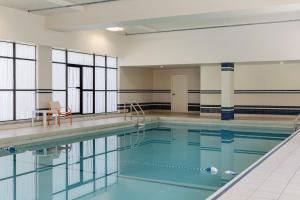 a swimming pool with a table and a chair at Holiday Inn Toronto Downtown Centre by IHG in Toronto