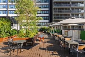 a patio with tables and chairs and a building at Holiday Inn Toronto Downtown Centre by IHG in Toronto
