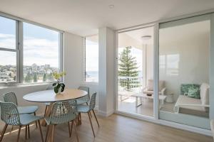 a dining room with a table and chairs at Stunning Beachfront penthouse-Beach District Views in Sydney
