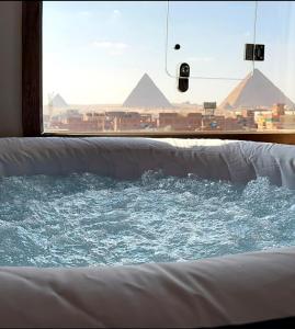 a view of a window with a view of pyramids at Aura Grand pyramids view inn in Giza
