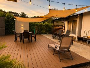 a wooden deck with a table and chairs on it at Villa Horizonte in Plazuela +15 photos