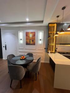 a kitchen and dining room with a table and chairs at Pcg Homes in Lagos