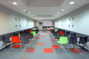 a room with colorful chairs and a whiteboard in it at OSiR Polna in Warsaw