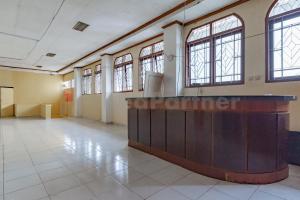 a large room with windows and a reception desk at Bojongsoang Guesthouse RedPartner in Bandung