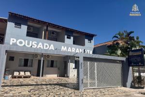 a building with a sign that reads pousada marawi st at Pousada Maranata in Aparecida