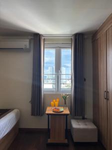 a hotel room with a table with oranges and a window at Sen Vàng Luxury Hotel in Nha Trang