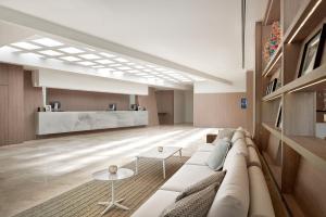 a living room with a couch and a table at Meliá Calviá Beach in Magaluf
