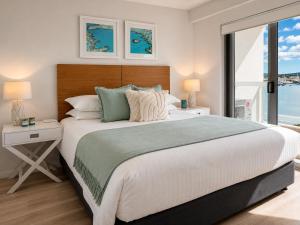 a bedroom with a large bed and a large window at Harbourfront Views at Allure 2 Bedroom Apartment in Townsville +19 photos