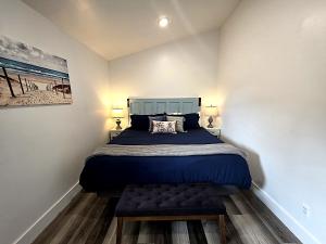 a bedroom with a bed with a blue bedspread at Bluff Hideaway - Guest House in Homer