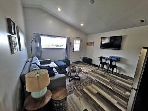 a living room with a couch and a table at Bluff Hideaway - Guest House in Homer