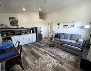 a living room with a couch and a table at Bluff Hideaway - Guest House in Homer