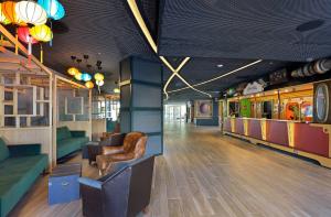 a living room with a couch and chairs in a room at SOL by Meliá Katmandú Park and Resort in Magaluf