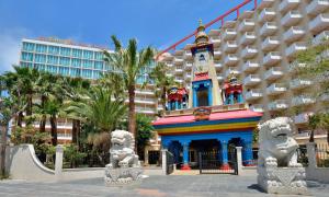 a building in front of a resort with two statues at SOL by Meliá Katmandú Park and Resort in Magaluf