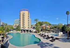 a resort with a pool and chairs and a building at SOL by Meliá Katmandú Park and Resort in Magaluf +66 photos