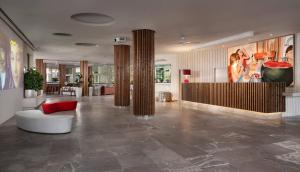 a lobby with columns and a couch and a table at Meliá South Beach in Magaluf