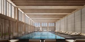 a large swimming pool in a building with chairs at The Dali EDITION in Dali
