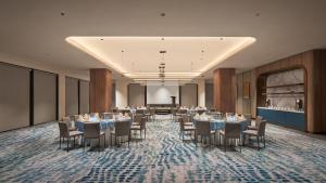 a banquet hall with tables and chairs in a room at voco Kuching by IHG in Kuching +72 photos